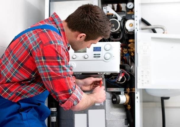 Técnico realizando mantenimiento en caldera eléctrica